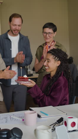 office birthday celebration with colleagues and cake