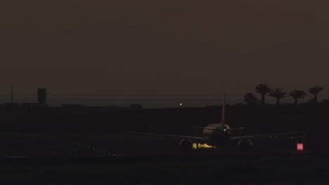 airplane taxiing down the runway