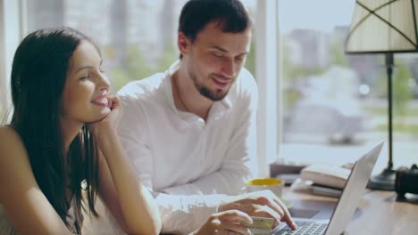 couple online shopping in cafe
