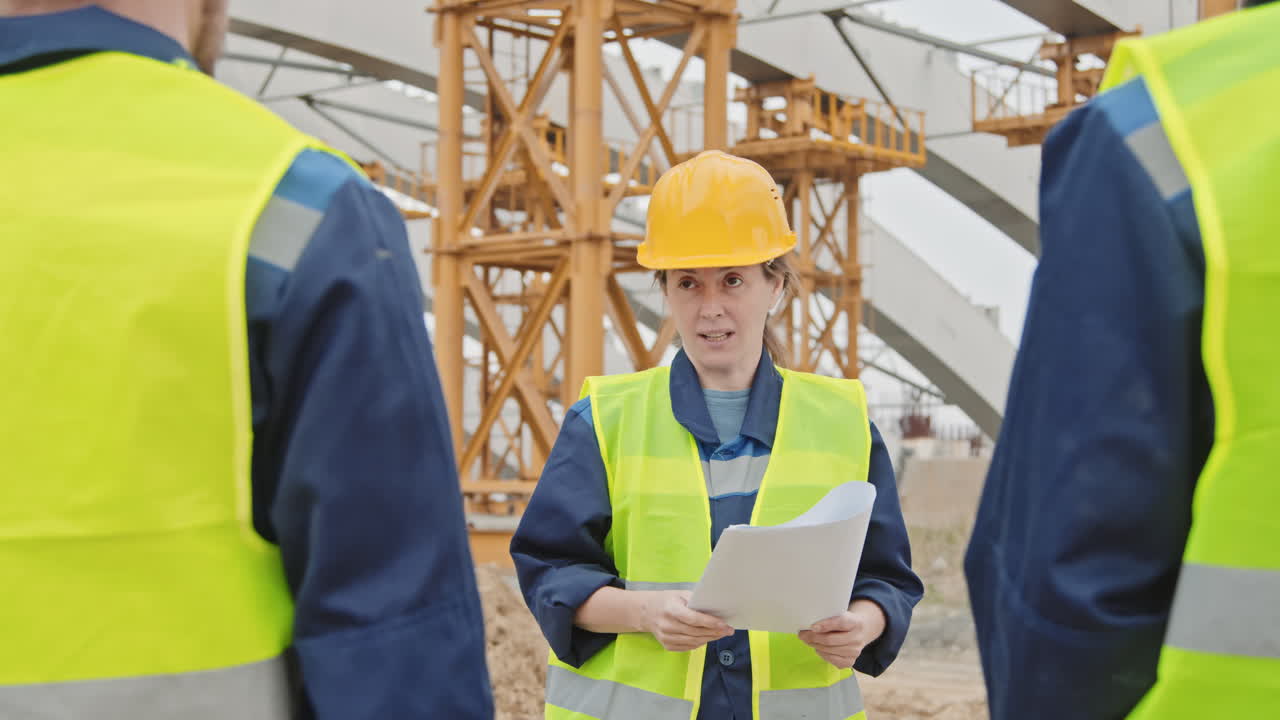 Construction Supervisor Giving Instructions to Workers