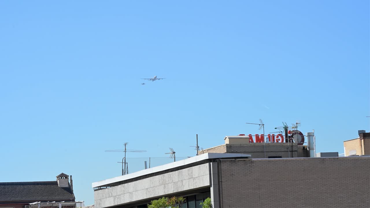A Spanish Air Force A330 MRTT tanker and F A-18 Hornet fly over Madrid. The aircraft perform during the National Day military parade, a tribute to the flag and Spain's Armed Forces