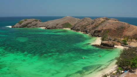 the white sand beach of tanjung aan in lombok, indonesia during a sunny day