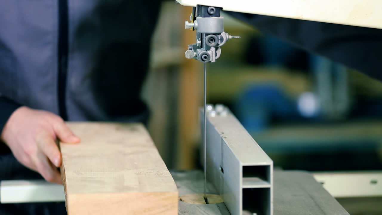Sawing A Wooden Plank With Jig Saw. Man uses an electric saw to cut wooden planks