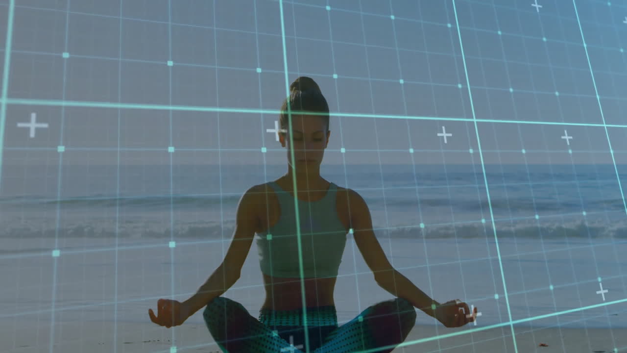 Meditating woman on beach with animation overlaying digital grid in scene