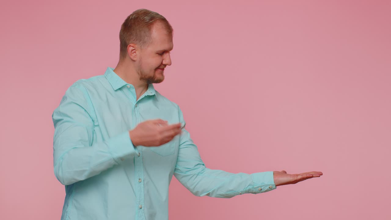 Man pointing empty place advertising area for commercial text copy space for goods promotion