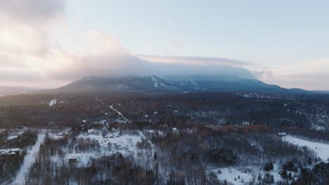 Snow-Covered-Rural-Landscape-With-Mountain-And-Foggy-Clouds-In-The-Background