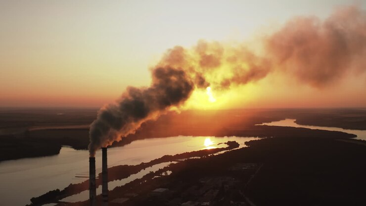 Plant with smoking smokestack. Problem of environmental pollution by factories