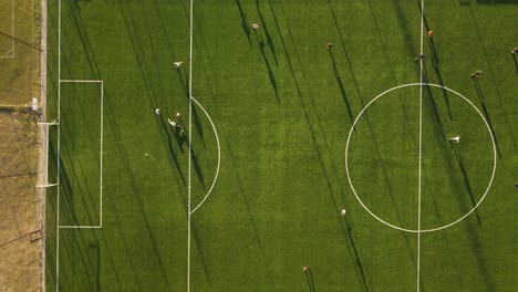Aerial-birds-eye-shot-of-team-passing-and-scoring-a-goal-during-soccer-football-match-in-stadium