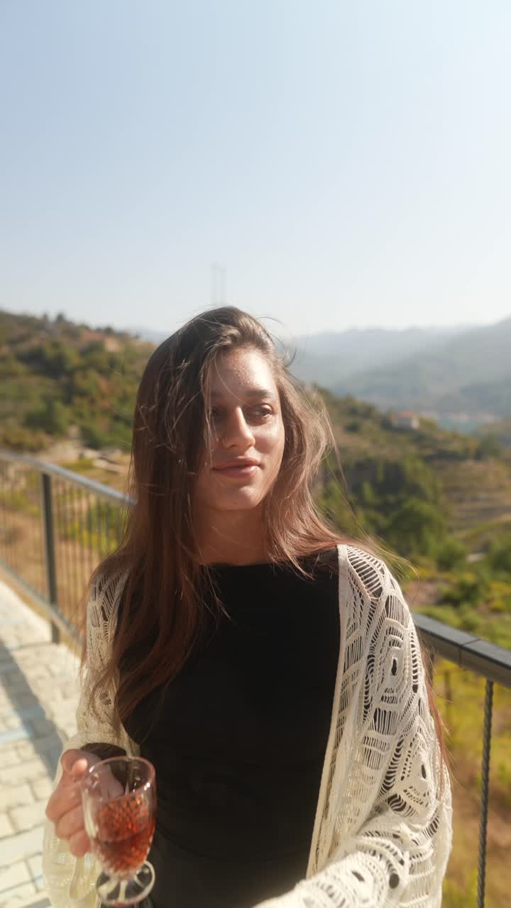 Woman enjoying tea on a mountain walkway