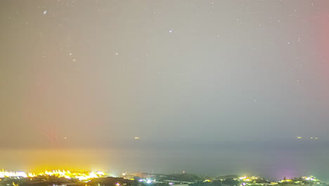 timelapse shot over the city of malaga, andalucia, spain at night time