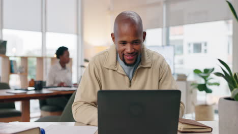 man working on laptop in modern office