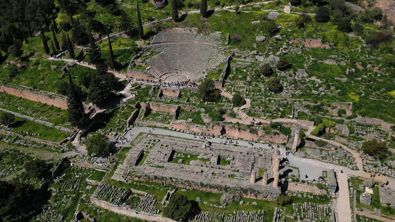 Delphi amphitheater and Temple of Apollo seen from drone orbit in Greek landscape