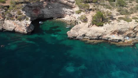 Spain-Mallorca-Cala-Llombards-and-Cala-Santanyi-at-4k-24fps-with-ND-filters-flying-with-a-DJI-Mavic-Air-with-beautiful-views-of-the-beaches,-rocks,-boats-and-blue-water