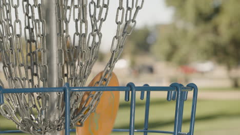 close up of disc golf frisbee putt hitting