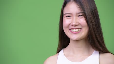 young happy beautiful asian businesswoman thinking