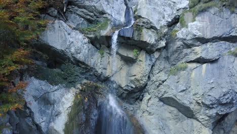 drone ascending in front of a waterfall in the austrian alps