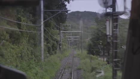 pov view out of back of train window on tracks, shaking as train is driving fast