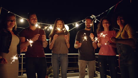 friends celebrating with sparklers at