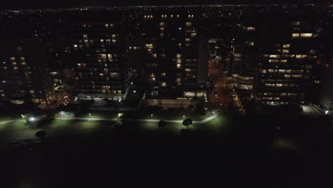 city of mar del plata at night in argentina. aerial view of urban tall buildings and park.