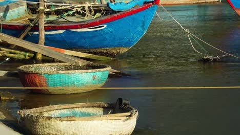 Boat-and-floating-basket-boats,-Vinh-Hy-Bay-fishing-marina,-Vietnam