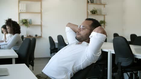 tired worker stretching in chair the returning back to laptop