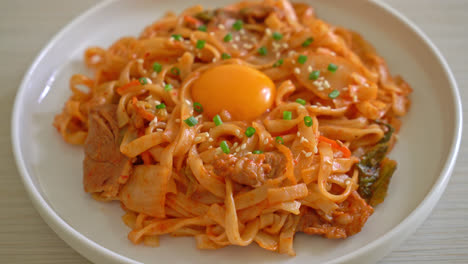 stir-fried udon noodles with kimchi and pork - korean food style