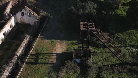 aerial shot of abandoned buildings and elevator towers in the ghost town of sao domingo mine, dark tourism