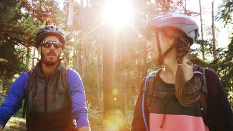 mountain biking couple pointing at nature