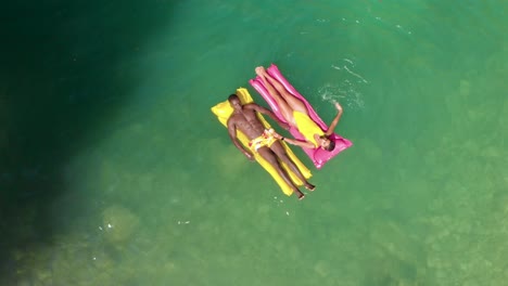 diverse couple chilling on floats