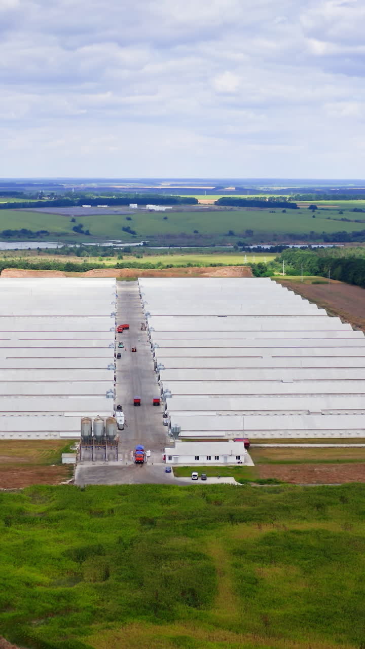 View from above on poultry farm. Newly built agricultural facilities in rural area. View from dron. Vertical video