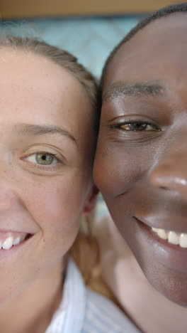 vertical video: smiling couple enjoying time together, close-up of their happy faces