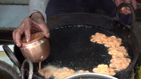 making the famous jalebi sweets in a market in nepal