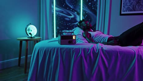 man relaxing in a neon lit bedroom