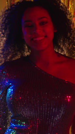 Vertical-Video-Of-Young-Woman-In-Nightclub-Bar-Or-Disco-Dancing-With-Sparkling-Lights-In-Background-5