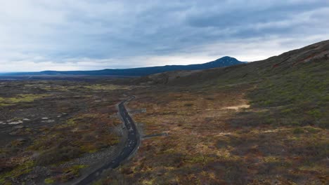 aerial view over gravel road located in the icelandic highlands showing the epic landscape and some majestic mountains in the background