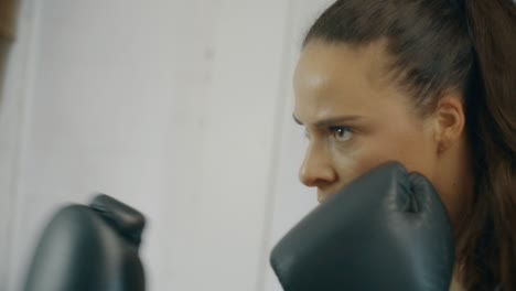 female boxer punching bag in slow motion