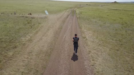 man running on a trail through a historical site