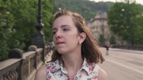 Woman-walking-in-Prague-city,-front-closeup-of-head-or-smiling-face