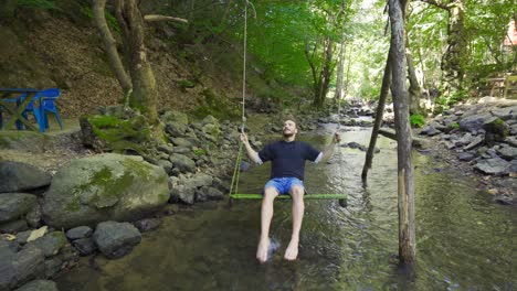 young man swinging on the swing.