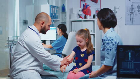 doctor checking child arm