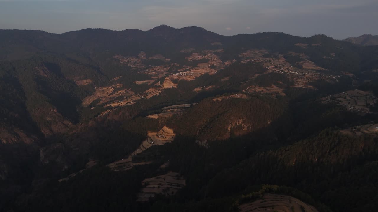 A wide landscape featuring forested hills and mountains, offering a breathtaking mountain view.