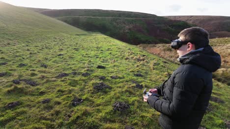 Kleiner-Junge-Und-Seine-Mutter-Draußen-Auf-Dem-Land,-Fliegen-Seine-FPV-Drohne-Mit-Einem-Virtual-Reality-Headset-Und-üben-Seine-Fähigkeiten-Im-Sport