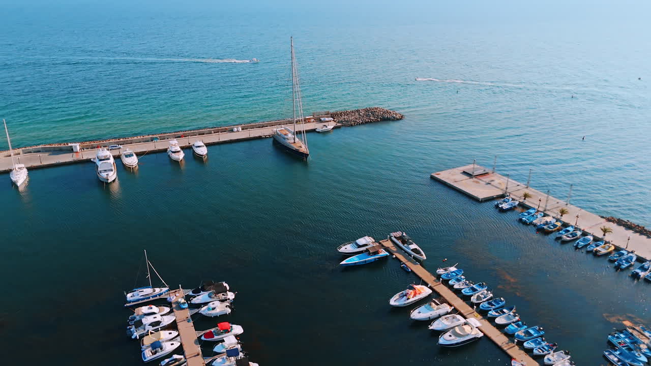 Aerial view of small pier and boats in Sveti Vlas, Bulgaria. Drone view of pier with boats and yachts on the Black Sea coast of Sveti Vlas, Bulgaria