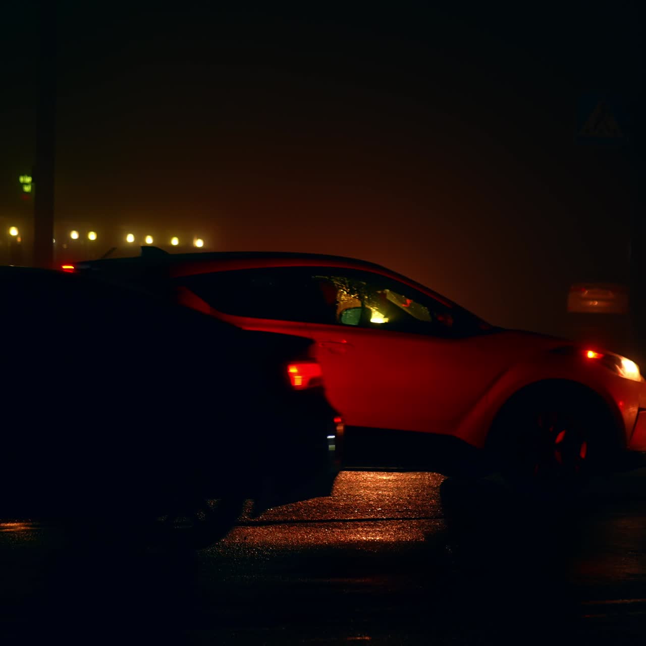 Traffic on the roads of dark city during blackouts. Energy crisis and electricity outage at nighttime