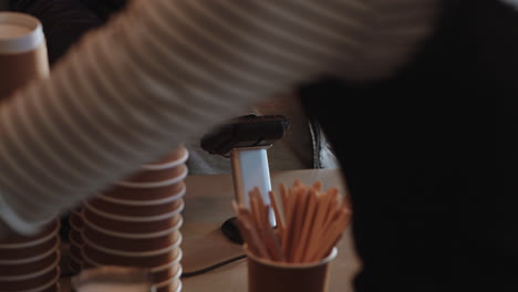 young woman paying using credit card transaction service buying coffee in cafe spending money at restaurant