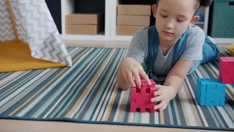 child playing with puzzle blocks