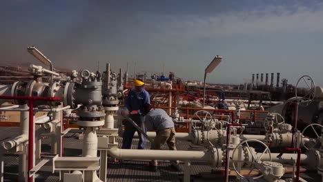 ws aerial view of workers work at a gas refinery