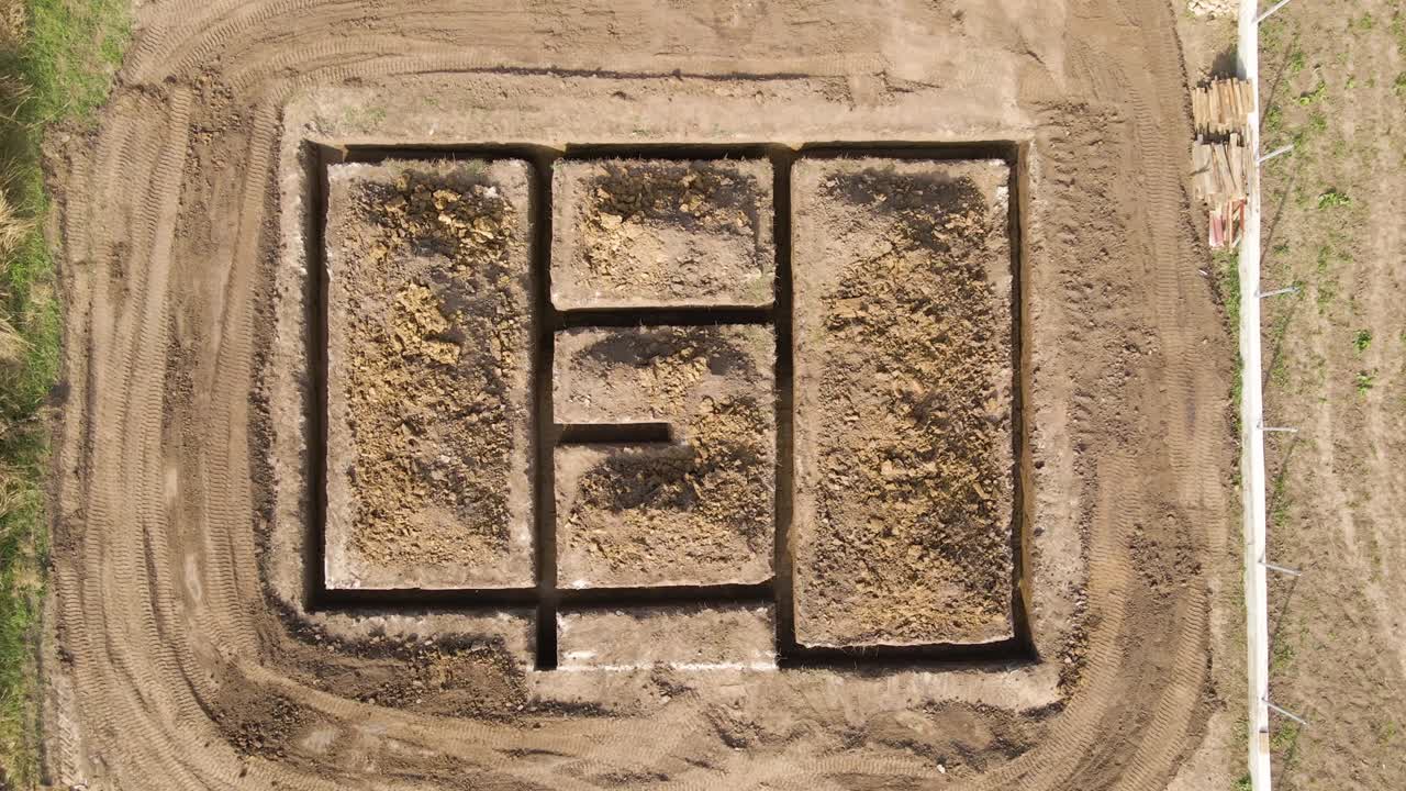 excavación de una zanja para la construcción de una nueva casa con cimientos de hormigón en el sitio de construcción