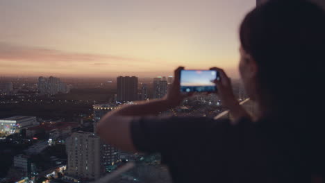 european girl take photo sunset