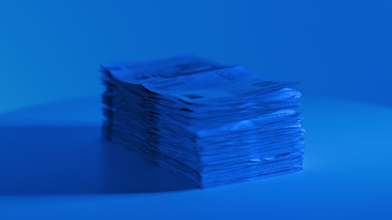Rotating euro cash pile on a platform with blue tones creating a modern mood